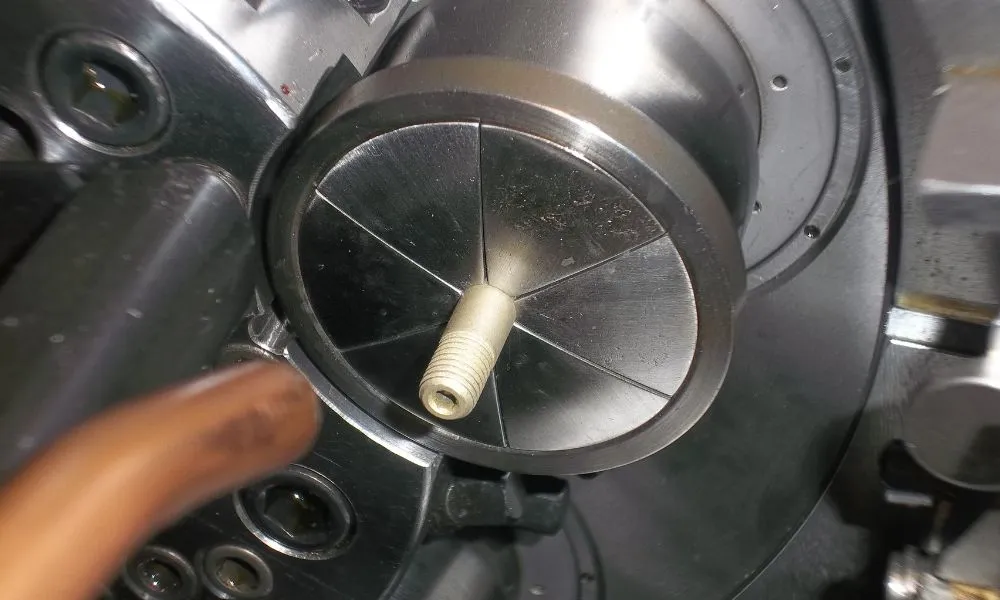 a metal circular object with a nut