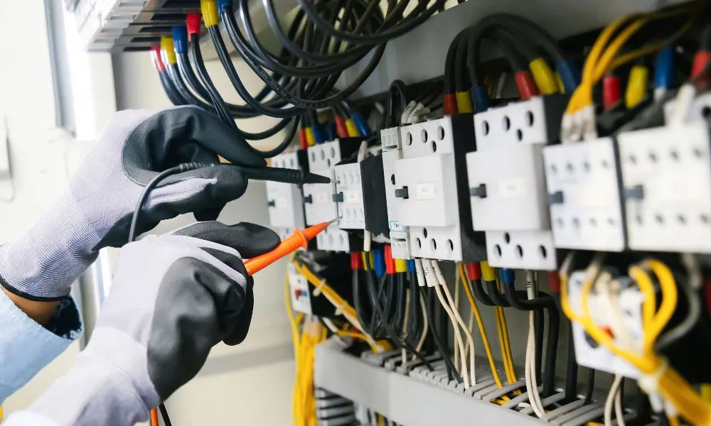 a person working on electrical equipment