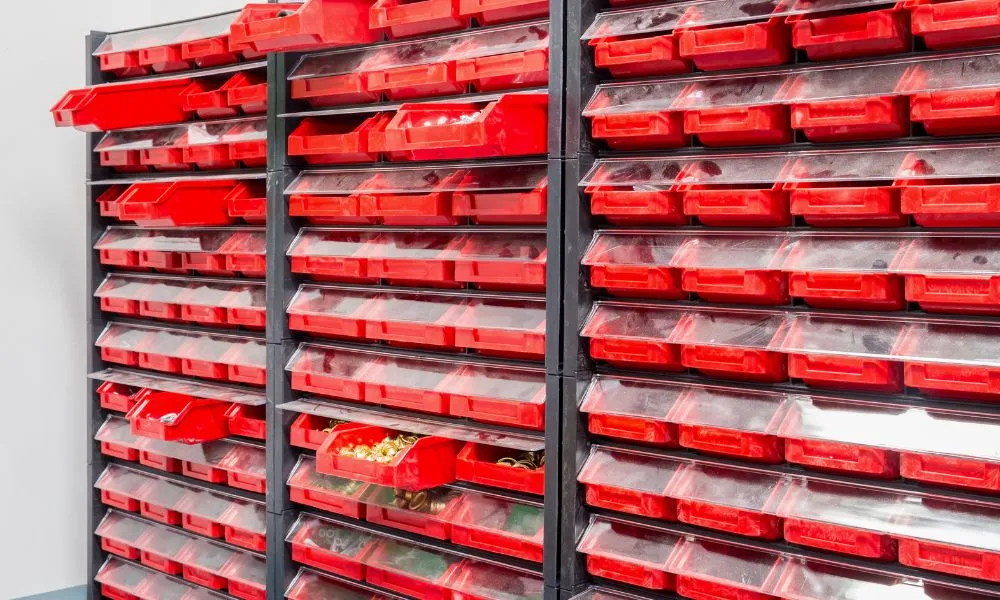 a shelf with red bins